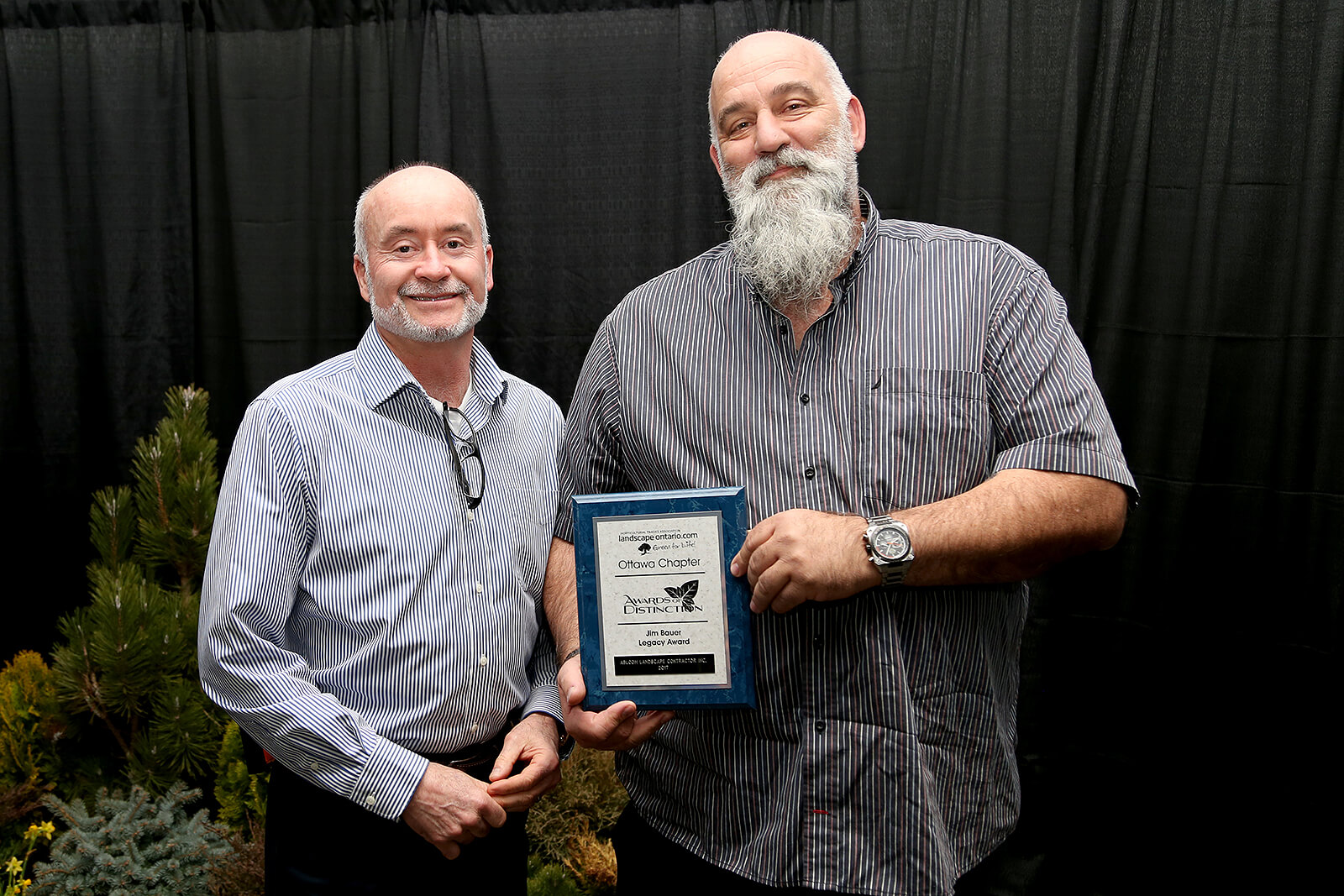 Bruce Morton (left) presents a Jim Bauer Legacy Award to Steve Neumann.