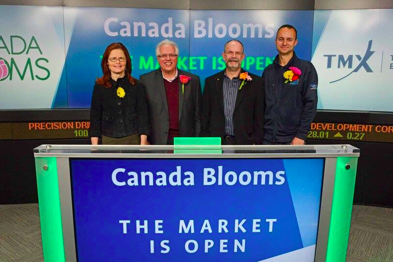 four people in front of a counter at the stock exchange