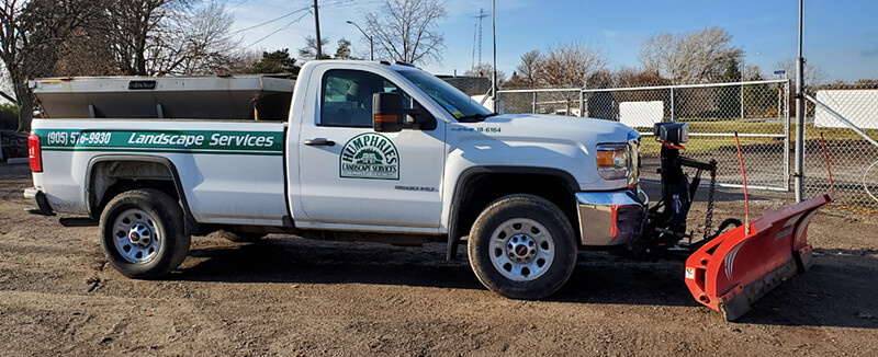 white pick up truck with snow blade