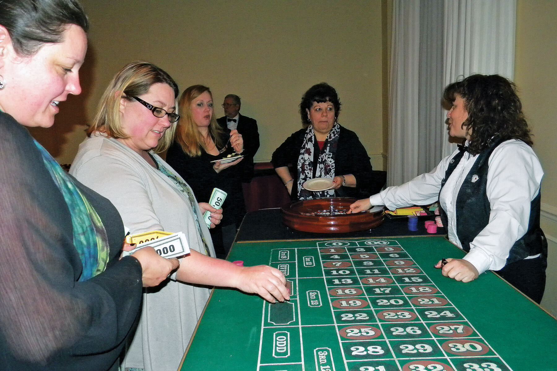 people playing at a casino table