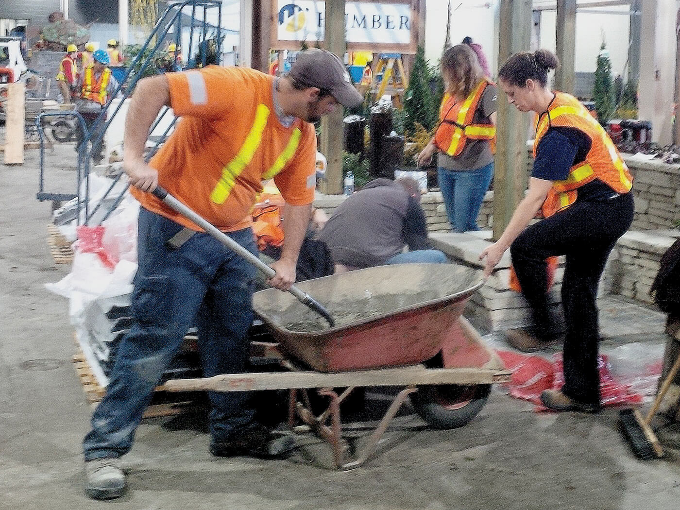 students working with a wheelbarrow