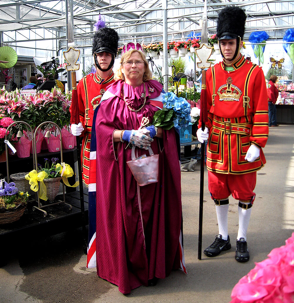 people dressed in costume in a greenhouse full of plants