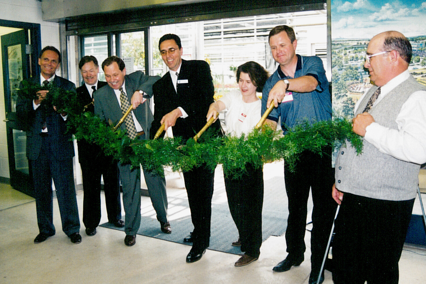 group of people cutting a ribbon