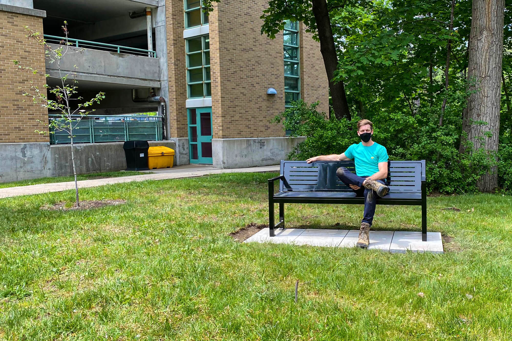 man sitting on a bench outside a hospital