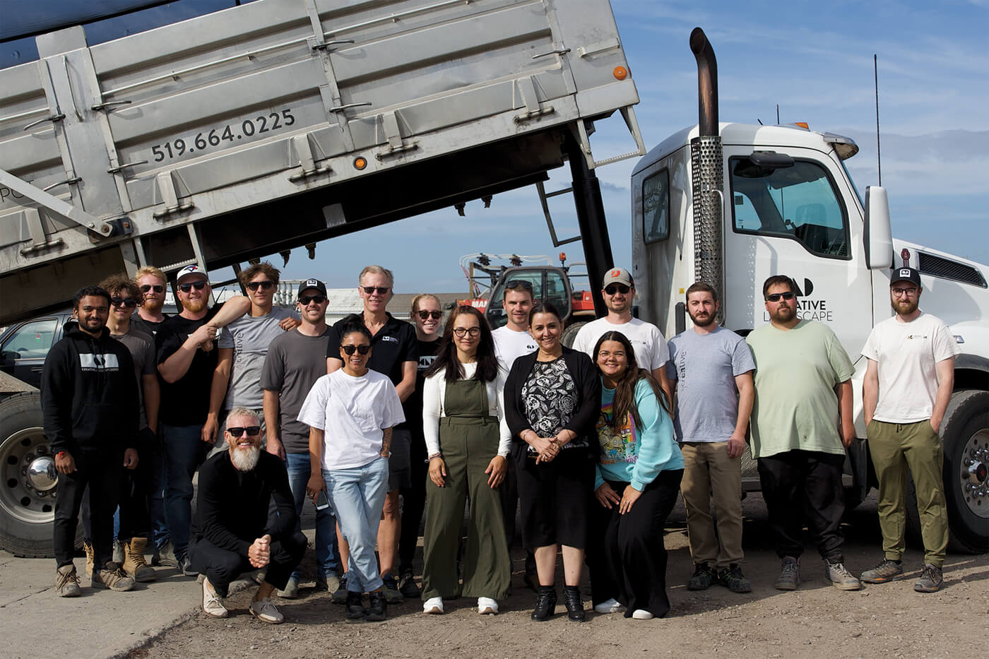 group of people standing in front of a truck