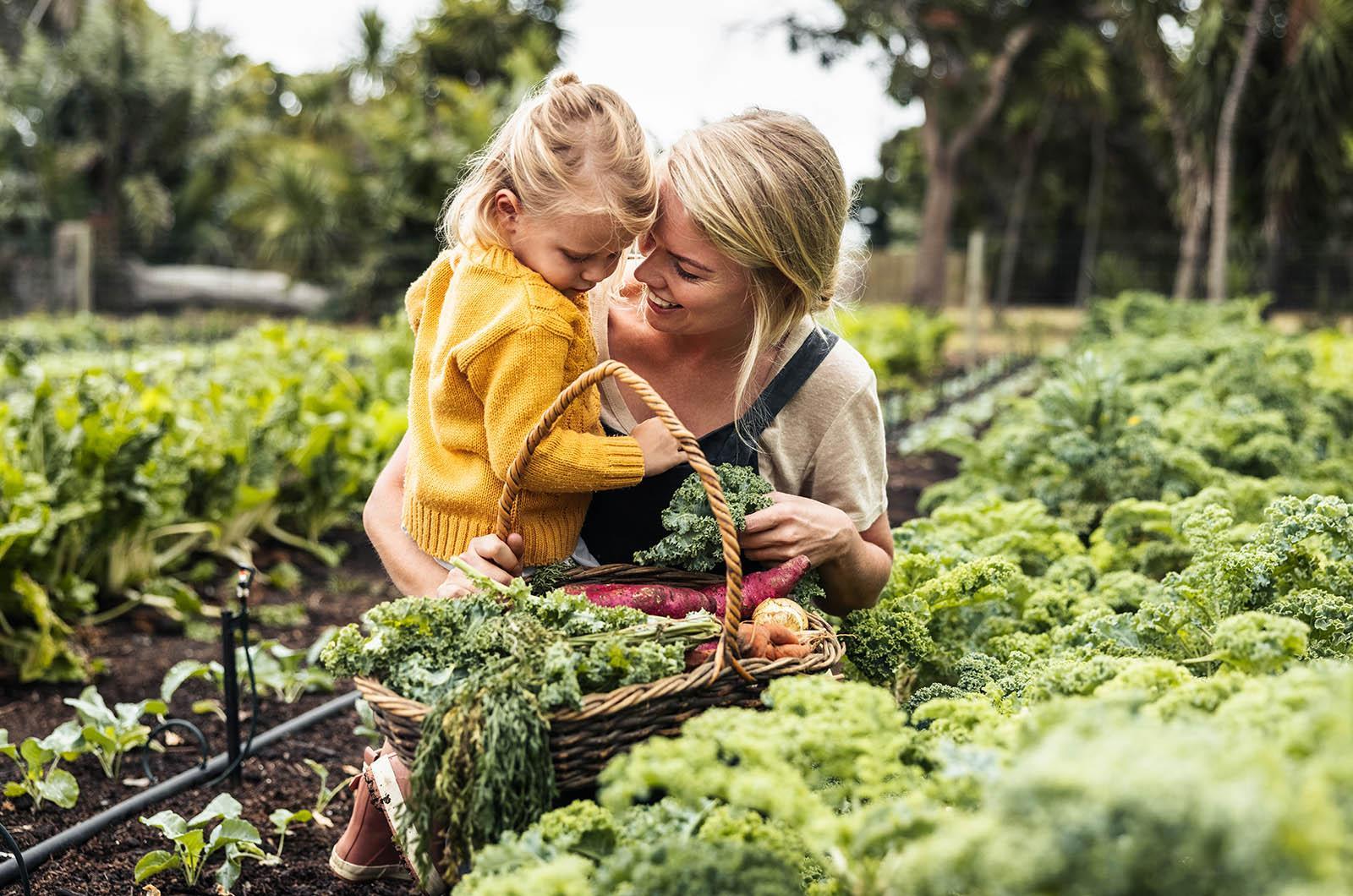 mom and daughter in vegetable garden